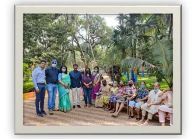 Orthocare team with elderly community members outdoors