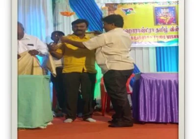 Dr. S. V. Ramesh being felicitated on stage at an award ceremony